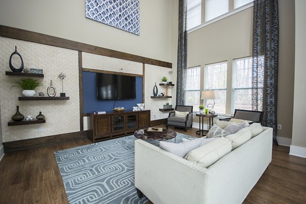 Modern clubhouse with lounge seating and billiard table at Tryon Place Apartments in Raleigh, ideal for social gatherings and relaxation