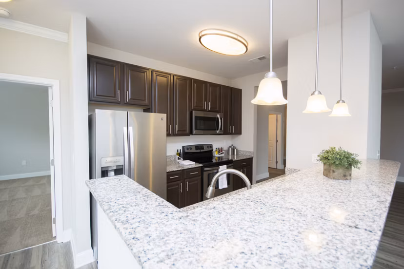 Modern kitchen with stainless steel appliances in Tryon Place Apartments