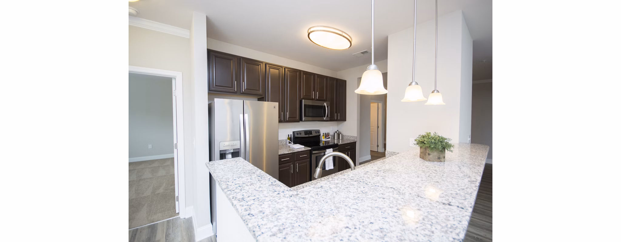 Modern kitchen with stainless steel appliances in Tryon Place Apartments
