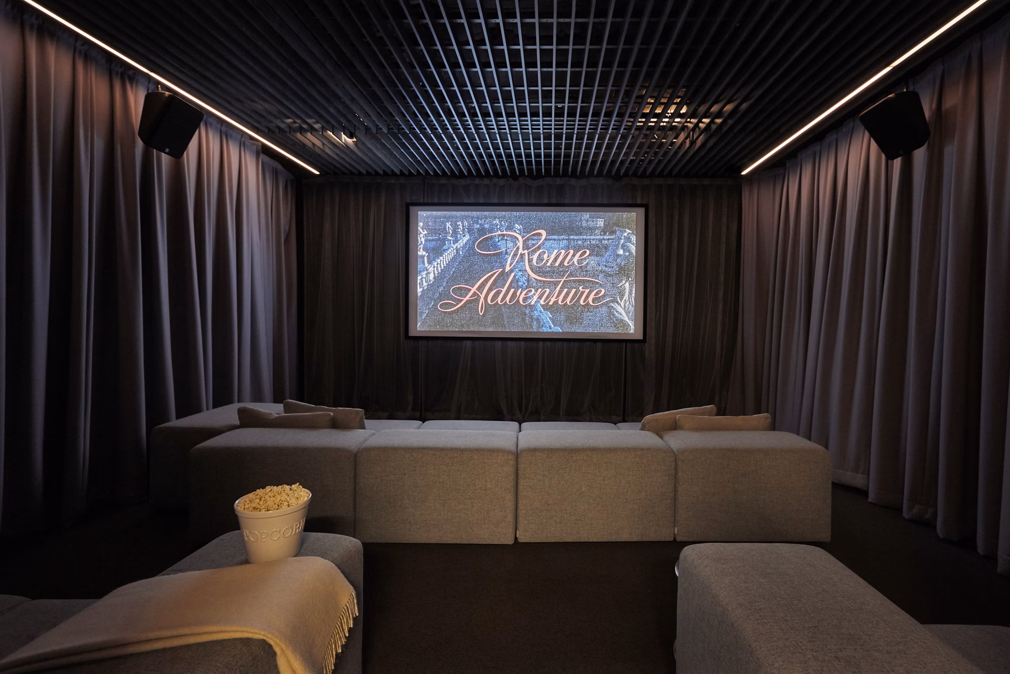 Jasper Apartments: Modern theater with plush seating and advanced sound system in luxury building