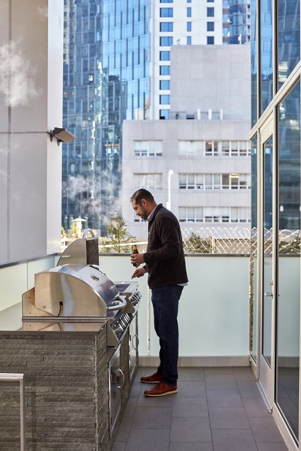 Grill area with modern barbecue stations at Jasper Apartments luxury residence