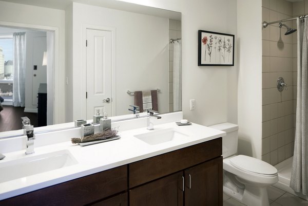 Modern bathroom with marble countertops and sleek fixtures at Edgewater Apartments, a luxury residence in Greystar's portfolio