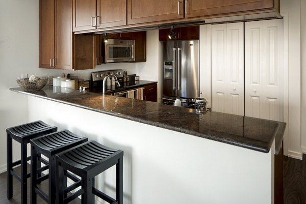 Kitchens featuring modern appliances and spacious countertops at Edgewater Apartments, luxury living by Greystar