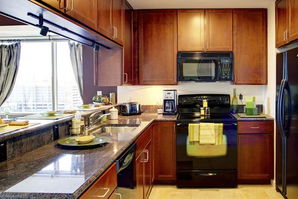 Modern kitchen with sleek countertops and stainless steel appliances at Edgewater Apartments