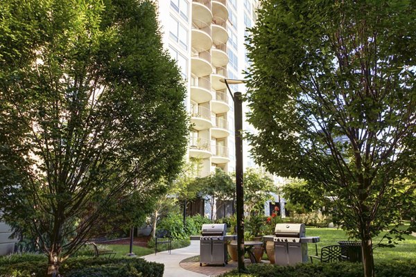 Outdoor grill area with modern seating at Edgewater Apartments, a luxury Greystar community perfect for social gatherings