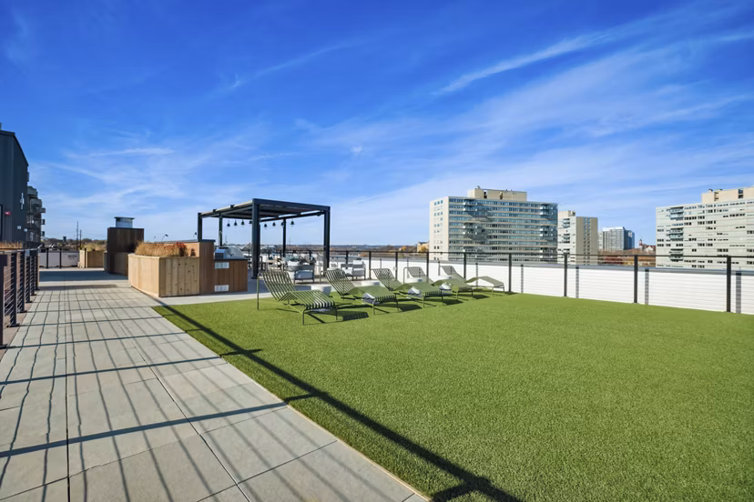 Rooftop deck with cozy seating and city views at Edgewater Apartments, offering luxury living spaces