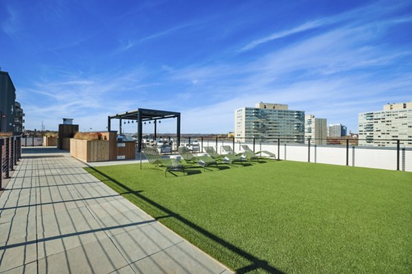 Rooftop deck with cozy seating and city views at Edgewater Apartments, offering luxury living spaces