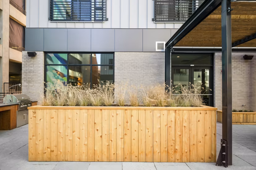 Courtyard with lush gardens and seating at Edgewater Apartments