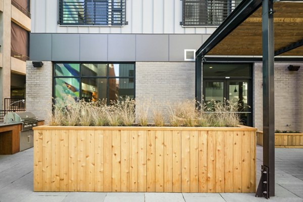 Courtyard with lush gardens and seating at Edgewater Apartments