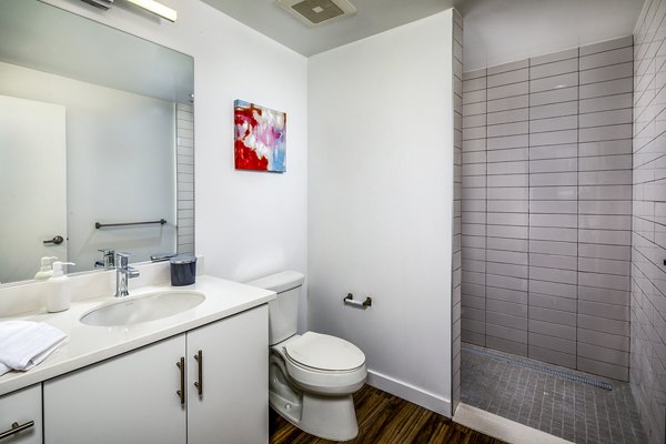 Modern bathroom with sleek fixtures and marble countertop at WILCO Apartments