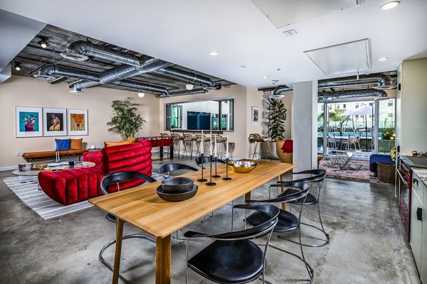 Clubhouse featuring modern design and comfortable seating at WILCO Apartments, offering residents a luxurious social space in a prime location