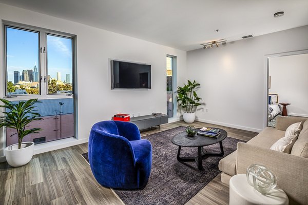 Spacious living room with modern decor and large windows at WILCO Apartments in the Greystar property collection