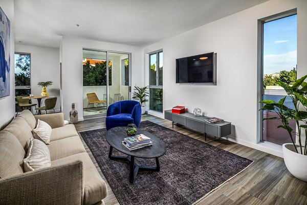 Modern living room with chic decor and large windows at WILCO Apartments
