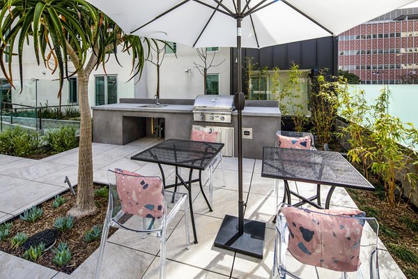 Grill area with modern seating at WILCO Apartments for outdoor dining and relaxation