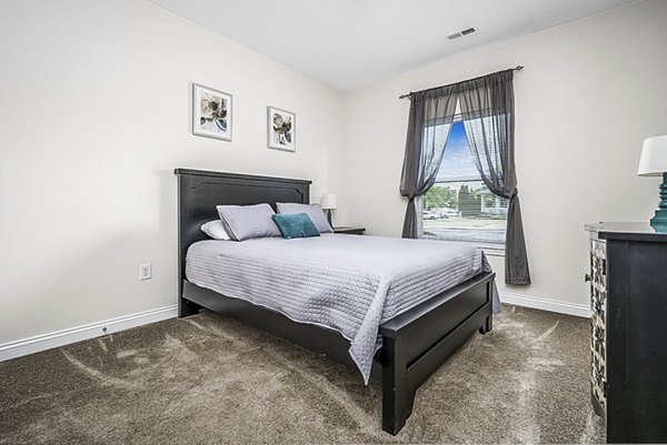 Bedroom featuring elegant design elements at Copper Chase at Stones Crossing Apartments
