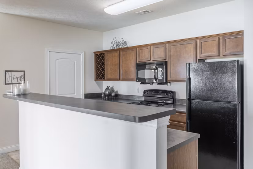 Modern kitchen with stainless steel appliances at Copper Chase at Stones Crossing Apartments