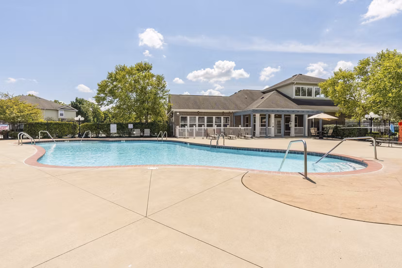 Outdoor pool with lounge chairs at Copper Chase at Stones Crossing Apartments