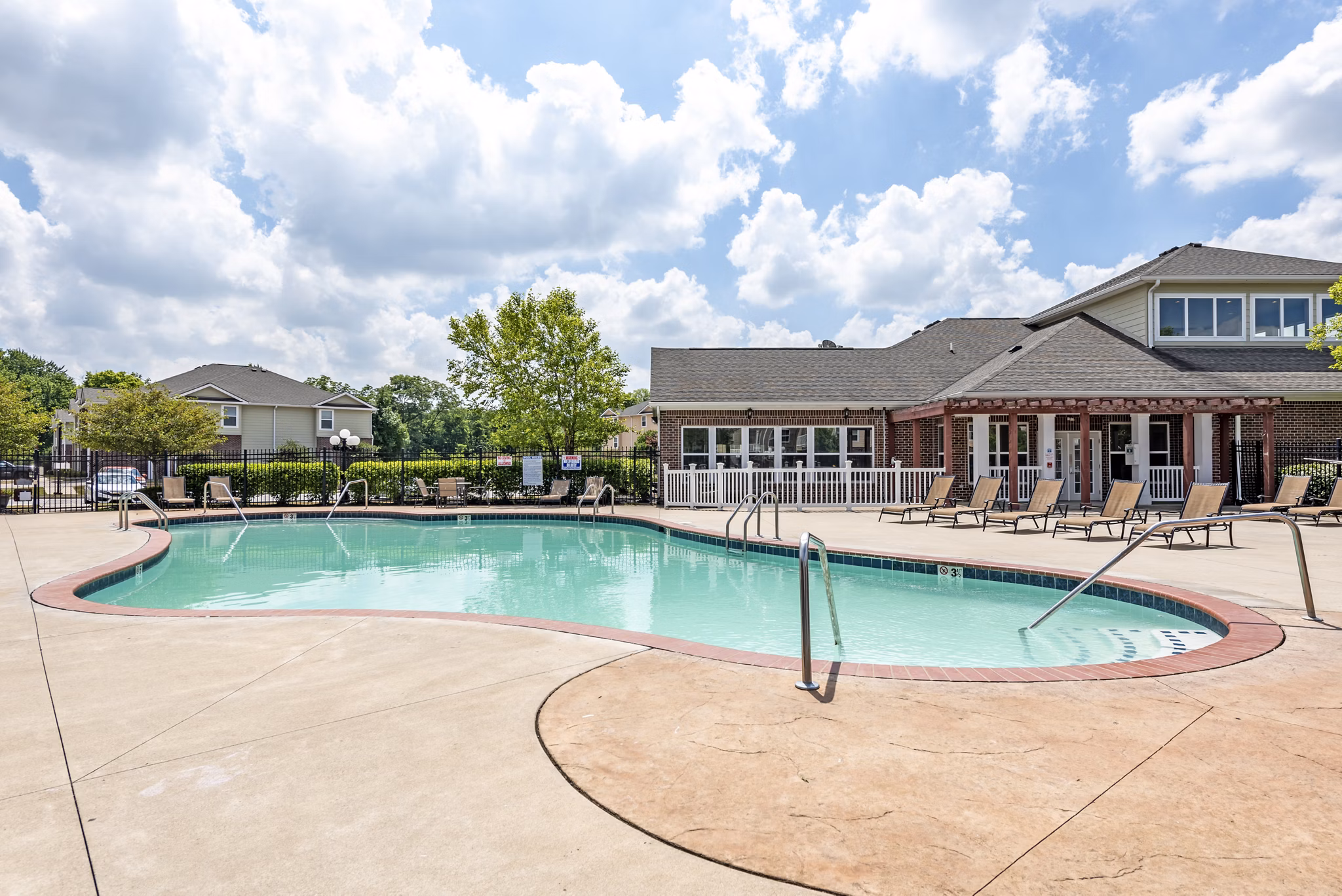 Outdoor pool with lounge chairs at Copper Chase at Stones Crossing Apartments