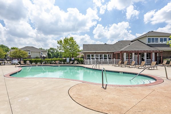 Outdoor pool with lounge chairs at Copper Chase at Stones Crossing Apartments