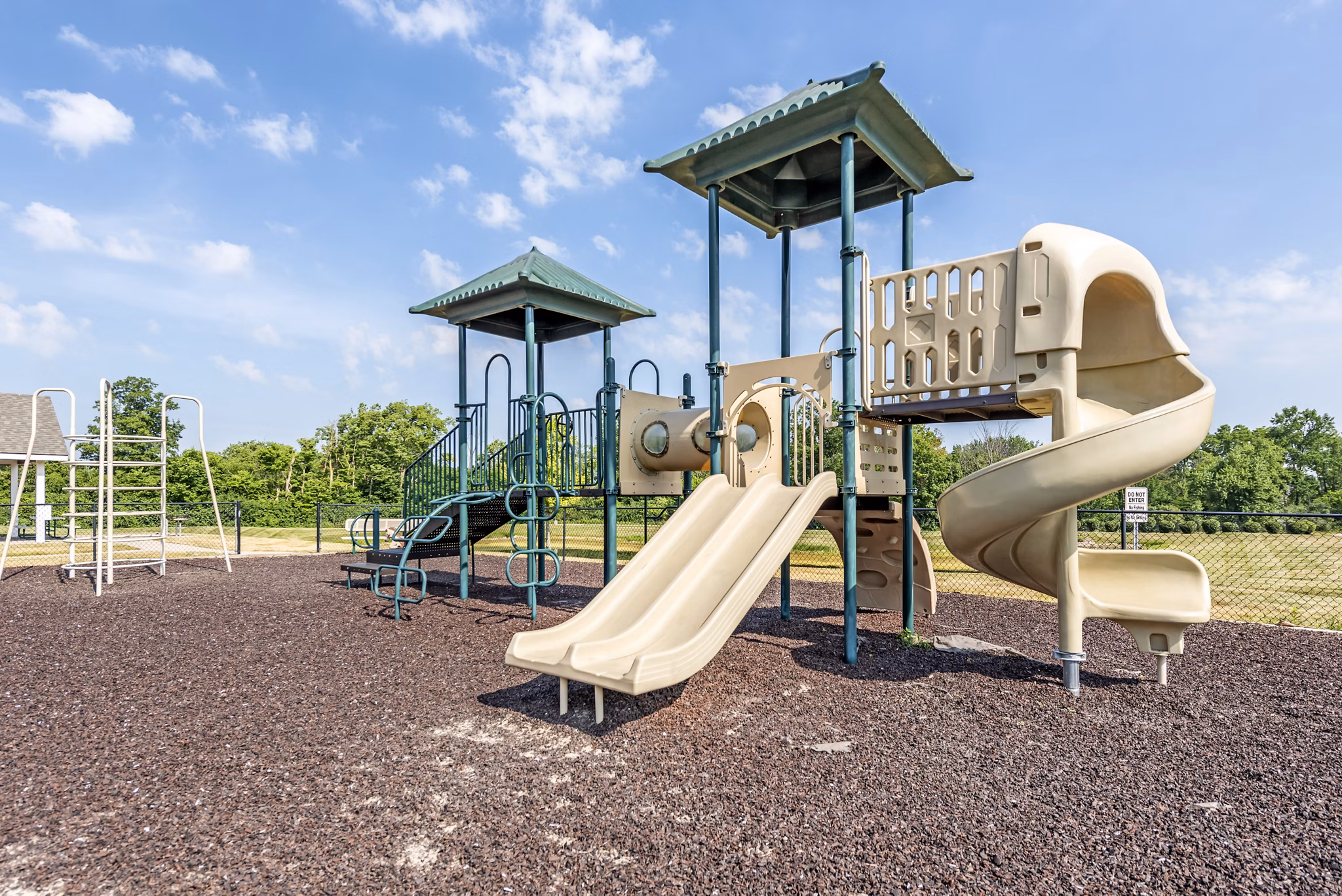 Outdoor playground with modern equipment at Copper Chase at Stones Crossing Apartments, ideal for family-friendly living and recreation