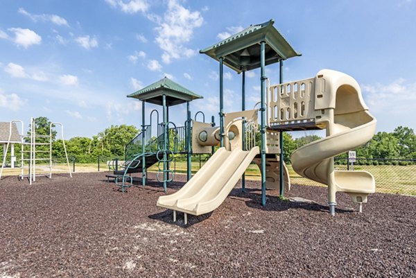 Outdoor playground with modern equipment at Copper Chase at Stones Crossing Apartments, ideal for family-friendly living and recreation