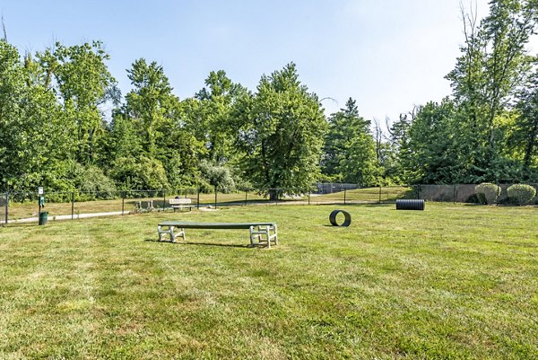 Dog park at Copper Chase at Stones Crossing Apartments featuring agility equipment and green spaces for pets to enjoy