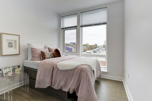 Modern bedroom with natural light and stylish decor at Wheelhouse Apartments