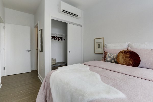 Inviting bedroom featuring contemporary design and plush bedding in Wheelhouse Apartments