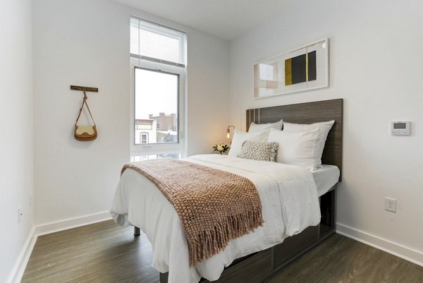 Bedroom featuring contemporary decor and ample natural light at Wheelhouse Apartments