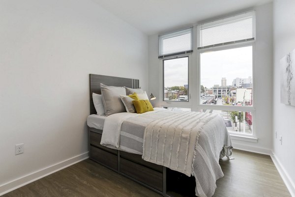 Cozy bedroom with modern furnishings in Wheelhouse Apartments