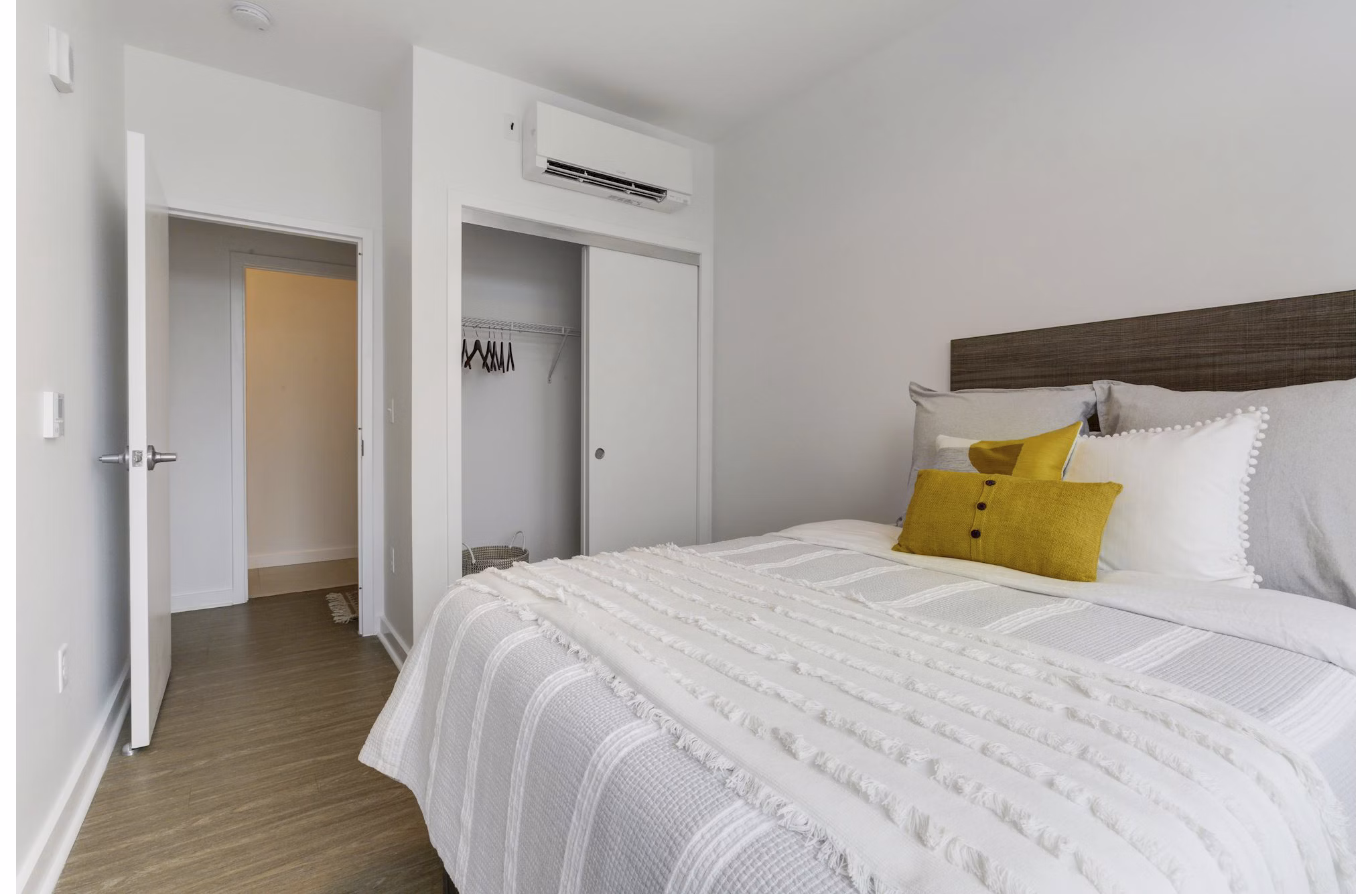 Cozy bedroom with modern furnishings at Wheelhouse Apartments, a luxury living space in an urban setting