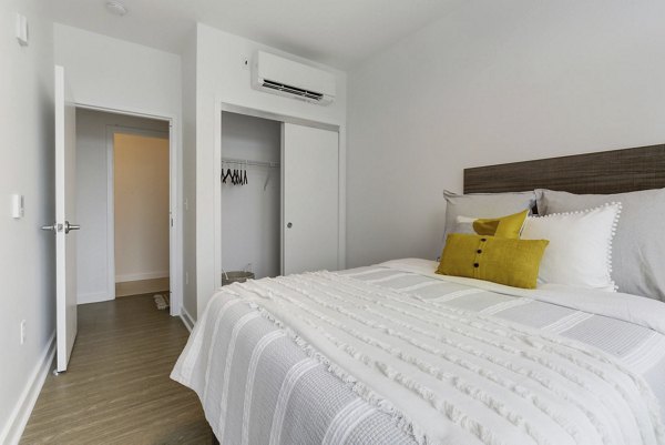 Cozy bedroom with modern furnishings at Wheelhouse Apartments, a luxury living space in an urban setting
