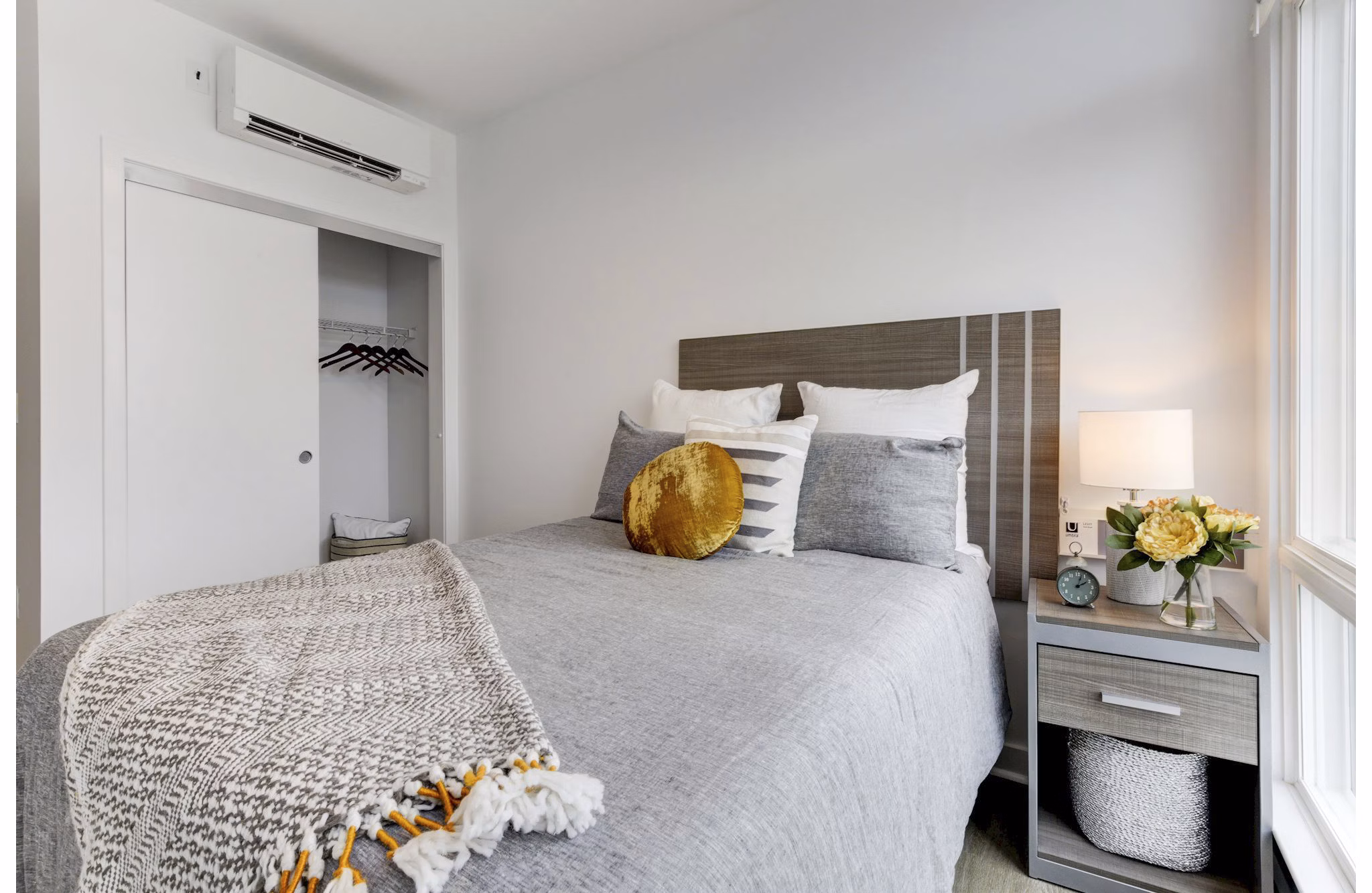 Cozy bedroom with modern furnishings at Wheelhouse Apartments, showcasing comfort and style for luxury living
