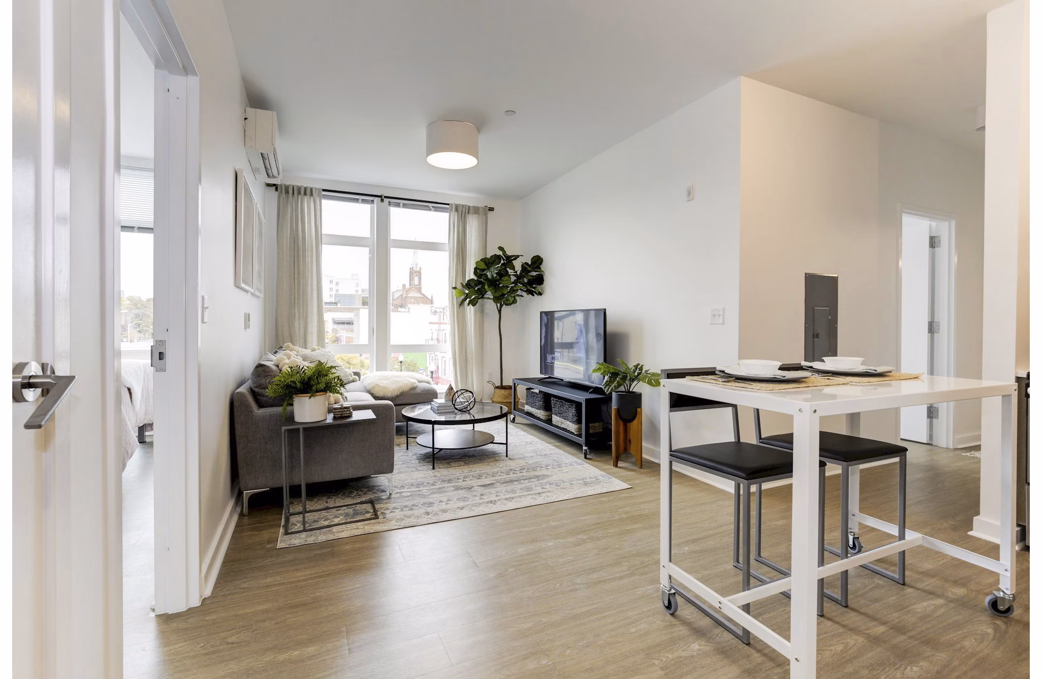 Living room with modern decor and large windows in Wheelhouse Apartments