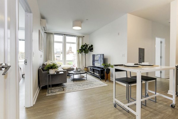 Living room with modern decor and large windows in Wheelhouse Apartments