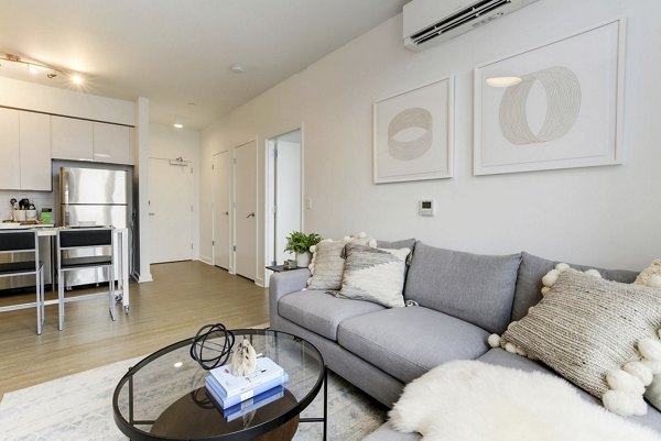Cozy living room with modern decor and ample seating at Wheelhouse Apartments