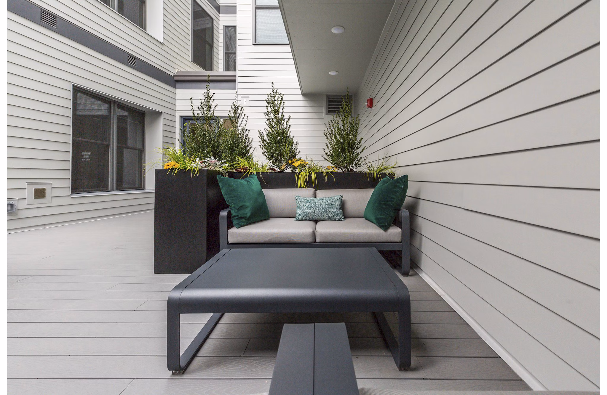 Cozy outdoor patio with comfortable seating at Wheelhouse Apartments, ideal for relaxation and alfresco dining
