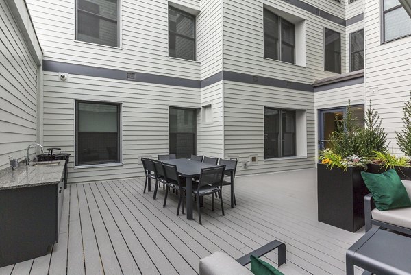 Courtyard with lush greenery and seating areas at Wheelhouse Apartments, ideal for relaxation and outdoor gatherings