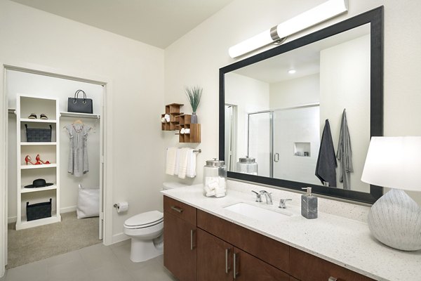 Modern bathroom with sleek fittings in The Upton at Longhorn Quarry Apartments, offering luxury living spaces in a serene neighborhood setting