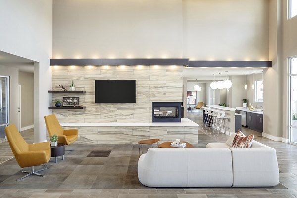 Clubhouse featuring modern furnishings and social gathering spaces at The Upton at Longhorn Quarry Apartments