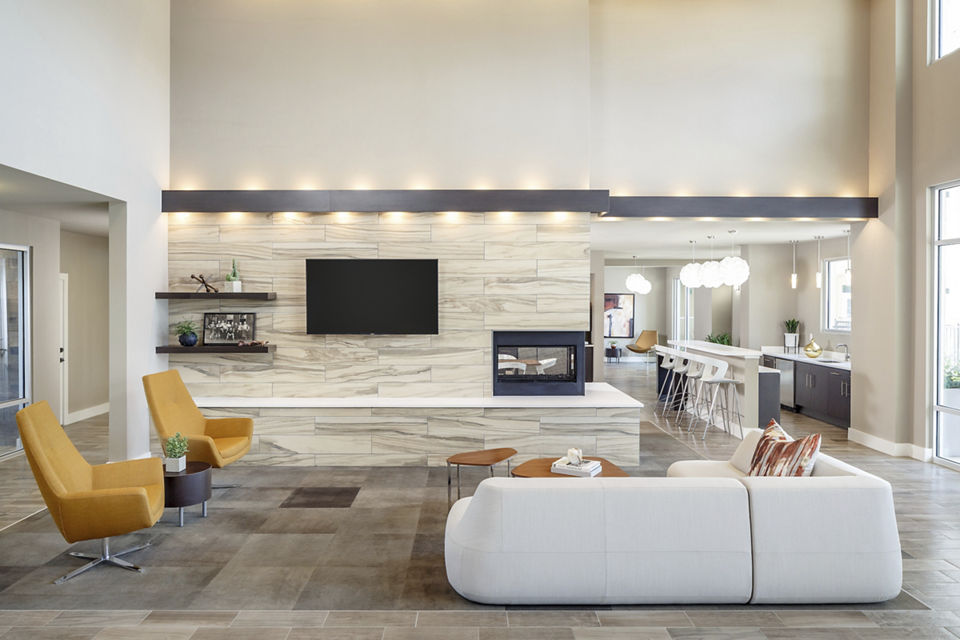 Clubhouse featuring modern furnishings and social gathering spaces at The Upton at Longhorn Quarry Apartments