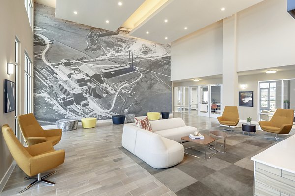 Modern clubhouse with plush seating and gaming area at The Upton at Longhorn Quarry Apartments in San Antonio