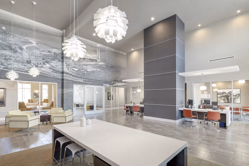 Clubhouse featuring modern lounge seating and billiards table at The Upton at Longhorn Quarry Apartments
