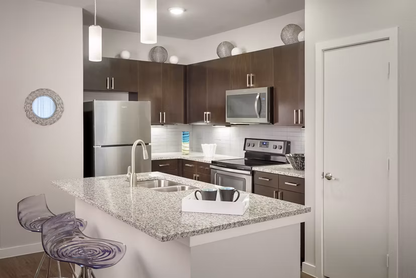 Kitchen with modern appliances and sleek countertops at The Upton at Longhorn Quarry Apartments