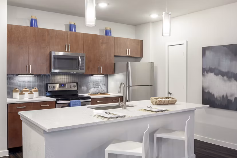 Modern kitchen with sleek cabinetry and stainless appliances in The Upton at Longhorn Quarry Apartments