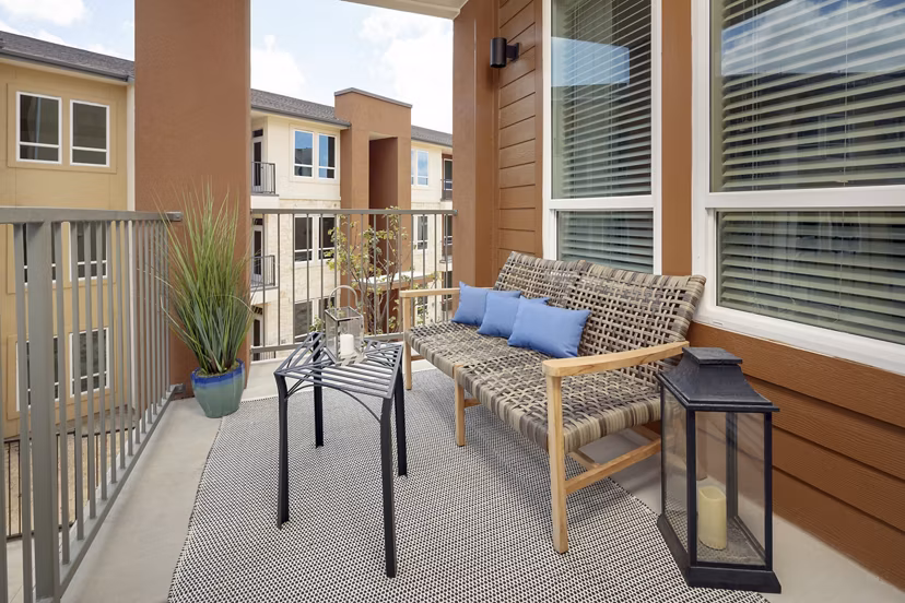 Patio with stylish outdoor seating at The Upton at Longhorn Quarry Apartments