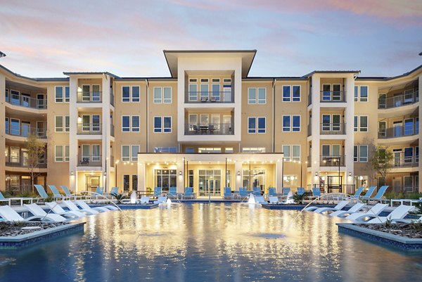 Rooftop pool with lounge chairs at The Upton at Longhorn Quarry Apartments