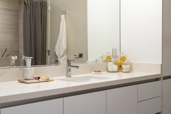 Bathroom featuring elegant fixtures and marble countertops at Linea Apartments, a luxury living space in the heart of the city