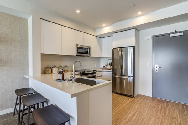 Contemporary kitchen with modern appliances at Linea Apartments