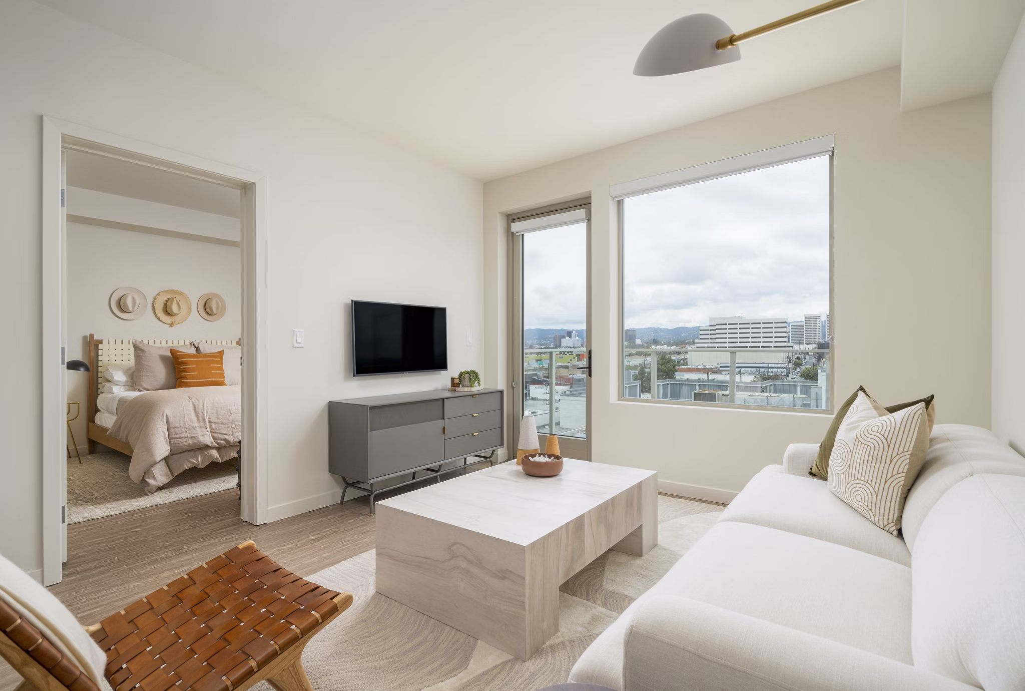 Modern living room with sleek furniture and large windows at Linea Apartments, offering luxury living in the heart of the city